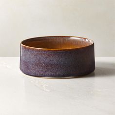 a brown bowl sitting on top of a white counter