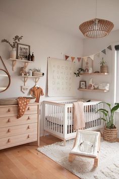 a baby's room with a white crib and wooden furniture