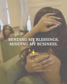 a woman covering her face with her hands and the words, minding my blessing, is