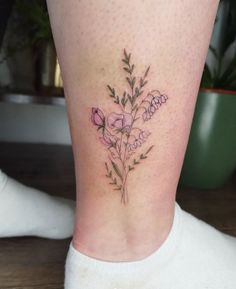 a woman's leg with a flower tattoo on her left side ribcage