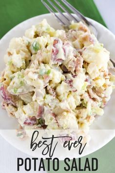 a white plate topped with potato salad next to a fork