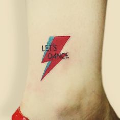 a woman's foot with a tattoo that says let's dance