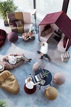 an overhead view of a living room with couches, chairs and tables in it