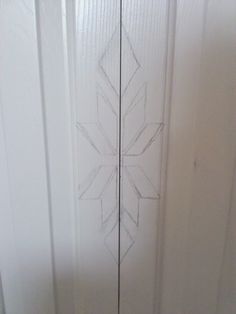 a white door with an etched design on it