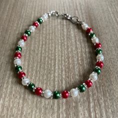 This lovely small Christmas bracelet made with glass pearls will make your Christmas Holiday season brighter!  Minimalist design features 4mm varnished glass pearls in red, green and white, a 304 stainless steel clasp, and tiny 2mm silver-lined glass beads nestled between the pearls for just the right amount of sparkle.  The classic Christmas colors are fun and festive, and it's super lightweight!    Do not wear while cleaning, bathing or swimming.  Store in a dark place, as bright light can fade the beautiful colors of the pearls. Christmas Party Beaded Bracelets, Christmas Holiday Bracelet Jewelry, Christmas Holiday Jewelry Bracelet, Red Christmas Bracelets For The Holidays, Red Christmas Bracelets For Holiday, Red Christmas Bracelet For Holiday, Holiday Festive Jewelry Bracelet, Red Christmas Festive Bracelets, Red Christmas Holiday Bracelet