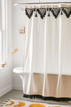 two pictures show the same shower curtain in different colors and styles, one with black trim