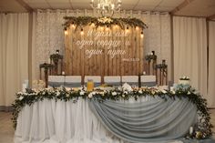 a table with flowers and candles on it in front of a sign that says, i love you