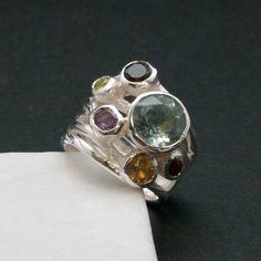 Big Multi Gemstone Statement Ring, Glamorous Wide Band 925 Silver Natural Gemstones, Blue Topaz High Fashion Ring, Fine Jewelry Gift for Her by SunSanJewelry on Etsy https://www.etsy.com/listing/475609499/big-multi-gemstone-statement-ring Unique Birthstone Gemstones For Jewelry Making, Unique Birthstones For Jewelry Making, Fusion Style Oval Multi-stone Gemstones, Anniversary Multi-stone Round Gemstones, Sterling Silver Multi-stone Topaz Ring, Unique Multi-stone Sapphire Ring For Anniversary, Unique Sterling Silver Sapphire Ring With Gemstone Accents, Fine Jewelry Multi-stone Gemstones In Sterling Silver, Unique Silver Multi-stone Cluster Ring