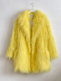 "Yellow, Oversize Fur Coat. Luxury, fluffy fabric, very soft. 100% polyester. Handmade made in London, UK.  Oversize style. Big collar. Long sleeves. Metal snap buttons (invisible) Two side pockets. Lenght 82cm - 1cm) Handmade in UK.  Model wears size S.  HOW TO CHOOSE A SIZE ?   Using a measuring tape, measure your bust, waist and hips (widest part) and compere with size chart.  SIZE CHART: (CM) B: Bust  H: Hips  XS - B: 83-88 cm  H: 90-95 cm  S - B: 88-93 cm H: 95-100 cm  M - B: 93-98 cm H: 100-105 L - B: 103-108 cm  H: 105-110 cm XL - B: 108-113 cm H: 110-115 cm CARE INSTRUCTIONS: Dry clean only, do not wash, do not iron, do not bleach.  Please message me before purchasing so I can check availability. If you wish this fur in any other colour, shorter or longer \"send message to seller\" Yellow Faux Fur Coat, Yellow Fur Coat, Fluffy Jacket Outfit, Fur Coat Outfits, Oversized Fur Coat, Oversize Coat, Fluffy Fabric, Oversize Style, Fuzzy Coat