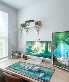 two computer monitors sitting on top of a wooden desk in front of a large window