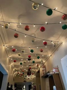 the ceiling is decorated with christmas ornaments and lights