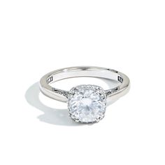 a white gold ring with an oval cut diamond in the center