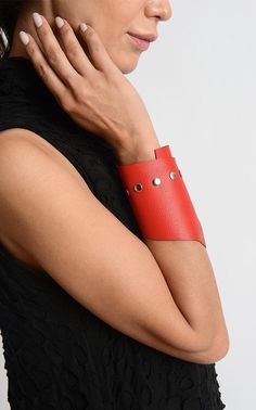 Red Oversize Cuff - METBR3 An extraordinary leather bracelet for people who simply adore accessories. This wide wristband is handmade of a special pattern leather in gorgeous red color. The leather had beed professionally processed in order to have a more interesting look. There is a line of studs on one side of the bracelet making it modern and daring while the lower part is asymmetrical. The bracelet is about 10 inches / 25 cm long and it closes with a snap button. NOTE! Since every piece is e Adjustable Leather Bracelet For Party, Adjustable Leather Party Bracelet, Leather Cuff Bracelets For Party, Adjustable Leather Cuff Bracelet For Party, Adjustable Leather Bracelets For Party, Party Leather Cuff Bracelets, Trendy Leather Bracelets For Party, Trendy Red Adjustable Leather Bracelet, Trendy Leather Party Bracelets