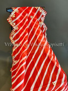 Red Organza Dupatta features a lehariya design with elegant embroidery and scalloped borders. Made from high-quality organza fabric, this dupatta is lightweight and comfortable to wear. Perfect for adding a touch of elegance to any outfit, it's a must-have for any fashionista. Lehariya Dupatta, Elegant Embroidery, Organza Dupatta, Organza Fabric, Borders, Red And White, Fabric, Red, How To Wear