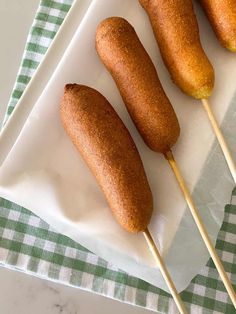 four fried food items on a plate with toothpicks