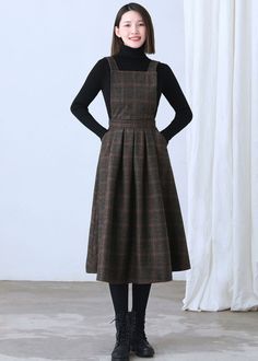 "★★FEATURES * Wool skirt * Polyester lining * Sleeveless * Two side seam pockets * Right hidden zipper closure * Adjustable strap * High waistband * Fit and flare * Perfect for winter, autumn, spring * Dry clean Fabric swatch https://etsy.me/3dIQDkz ★★ The model is 170 cm (5′ 7″) tall with a 80 cm (31.5\") bust, 66 cm (26\") waist. She is wearing the plaid wool dress in size XS. ★★ Bespoke Order Service If you Request other color Request the length Your height is not between 155 cm- 172 cm Your Winter Wool Tweed Dress Knee-length, Knee-length Wool Tweed Dress For Winter, Winter Wool Tweed Knee-length Dress, Brown Workwear Dress With Pockets, Sleeveless Plaid Dress With Pockets, Winter Midi Dress With Pockets, Fall A-line Dresses With Pockets, Winter Workwear Tweed Midi Dress, Fall Dresses With Slip Pockets