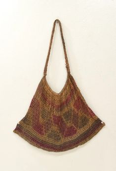 a brown and red purse hanging on a wall