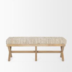 a bench made out of wood and upholstered with fabric on the seat, in front of a white background