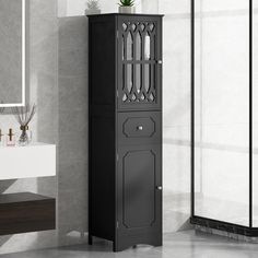 a tall black cabinet sitting next to a sink