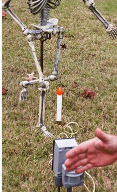 a skeleton is standing in the grass with an electronic device attached to it's body