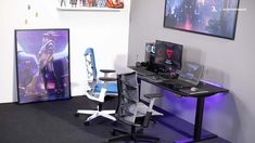 a desk with two computer monitors sitting on top of it next to a purple chair