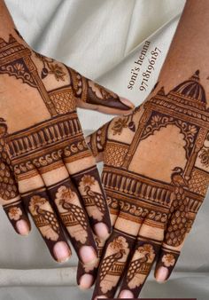 two hands with henna designs on them