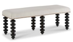 an upholstered bench with black wood legs