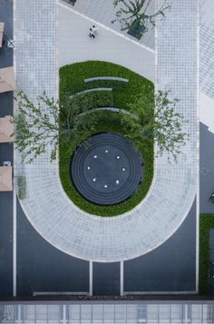 an aerial view of a park with benches and green plants on the ground, from above