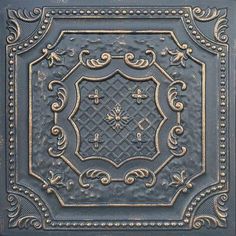 an old fashioned metal ceiling tile with ornate designs on the top and bottom half of it