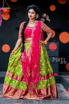 a woman in a green and pink lehenga