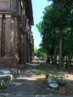 an old brick building sitting next to trees