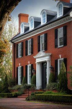 a large red brick house with black shutters