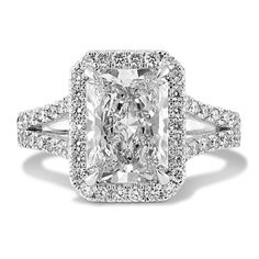 an engagement ring with a cushion cut diamond in the center and pave set shoulders