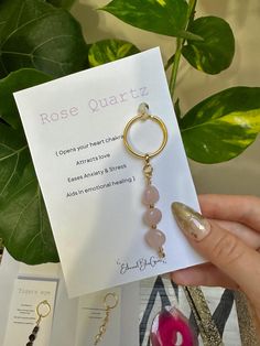 the rose quartz keychain is attached to a card