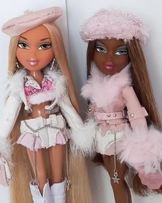 two dolls are standing next to each other