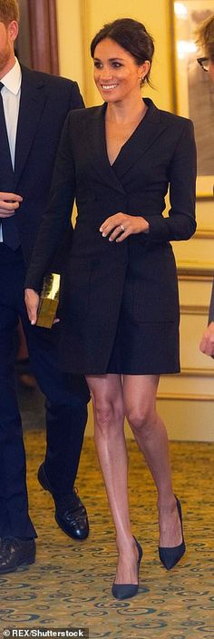 prince harry and his wife, princess charlotte, are walking through the lobby at buckingham palace