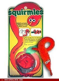 an orange stuffed animal is in front of a red package with the word squirmis on it