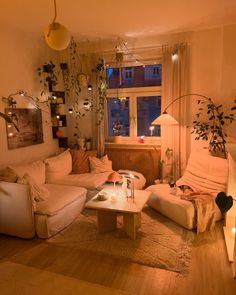 a living room filled with lots of furniture next to a fire place in front of a window