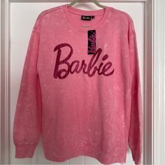 a pink sweatshirt with the word barbie on it