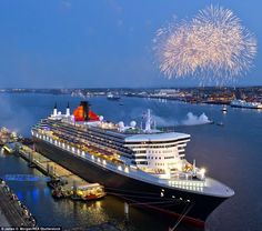 a cruise ship is docked with fireworks in the sky