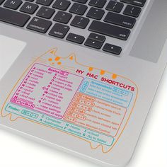 a laptop computer sitting on top of a white table with a sticker that says my mac shortcuts