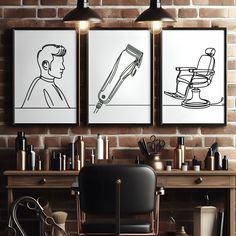 three black and white pictures hanging on a brick wall above a desk with a chair