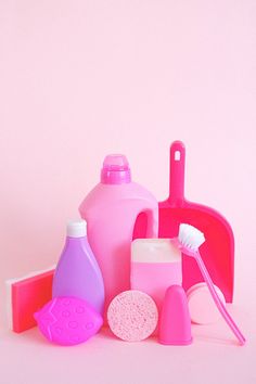 pink and purple bathroom accessories against a pink background