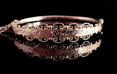 "A superb antique Edwardian 9ct gold floral engraved bangle.  A very pretty design with a slim plain polished back.  The front is wider with an elaborate floral engraving bordered by gold beading and scroll work.  A truly beautiful and intricate design, it is yellow gold with rosey hues depending on how the light hits.  The bangle is fully hallmarked for 9ct gold Birmingham 1909. The back is hollow and it has a push clasp and attached gold safety chain.  Approx measurements: 7.45\" outer circumference  2.25\" inner width  1.90\" inner length  Front 12.2mm width  Back 3.2mm width  Weighs 6.22 grams Condition:  Good used condition overall, some light surface wear commensurate with age, one small ding to the reverse, see photos.  Any questions or queries please contact us. FREE WORLDWIDE SHIP Floral Engraving, Engraved Bangle, Scroll Work, Gold Cross Pendant, Gold Engraving, Safety Chain, Gold Bangle, Pretty Design, Vintage Turquoise