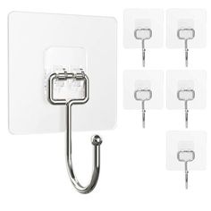 six pieces of glass and metal hooks with white tags on the wall behind them