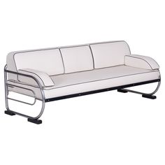 a white couch sitting on top of a metal frame