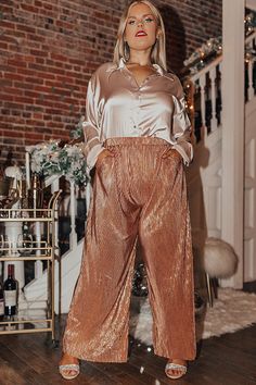 - The trendiest pants of the season have arrived! - Light weight, metallic rose gold colored pleated material - High elastic waistline - Hidden functional side pockets - Ultra relaxed silhouette that ends in straight floor length hemlines Measurements 1XL : Front Rise 14.5", Hip 42", Inseam 28", Length 42", Waist 34-36". 2XL : Front Rise 15", Hip 44", Inseam 28", Length 42", Waist 36-38". 3XL : Front Rise 15.5", Hip 46", Inseam 29", Length 43", Waist 38-40". Gold Party Bottoms With Pockets, Metallic Party Pants With Pockets, Endless Night, Trendy Pants, Metallic Rose Gold, Pleated Pants, Women Clothing Boutique, Hip Length, Online Womens Clothing