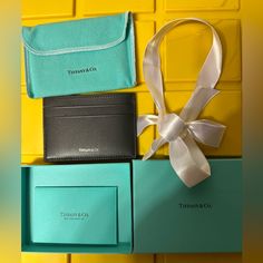 three different types of wallets sitting next to each other on yellow and green boxes