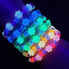 These kandi bracelets are made with rainbow,glitter pony beads and cute glow flower beads. This Item glows under the blacklight and in the dark! These measure 7 inches. Includeds 6 kandi bracelets one in each color. This Item is made to order. Perfect for any event! You will get lots of compliments in this unique wearable art! Stand out at your next event! Edm festival  Raves Party  Rave outfit  Festival outfit Pride Party favor Birthday gift Stocking stuffer Christmas gift Glow party Rave birthday  Rave gift Cheap Personalized Beaded Bracelets For Rave, Rainbow Beaded Bracelets For Rave, Rave Style Plastic Jewelry For Festivals, Rave Style Plastic Beaded Bracelets, Multicolor Plastic Beaded Bracelets For Rave, Pink Plastic Rave Bracelets, Flower Kandi Bracelet, Kandi Kids, Kandi Singles