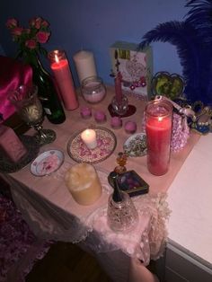 a table topped with candles and other items